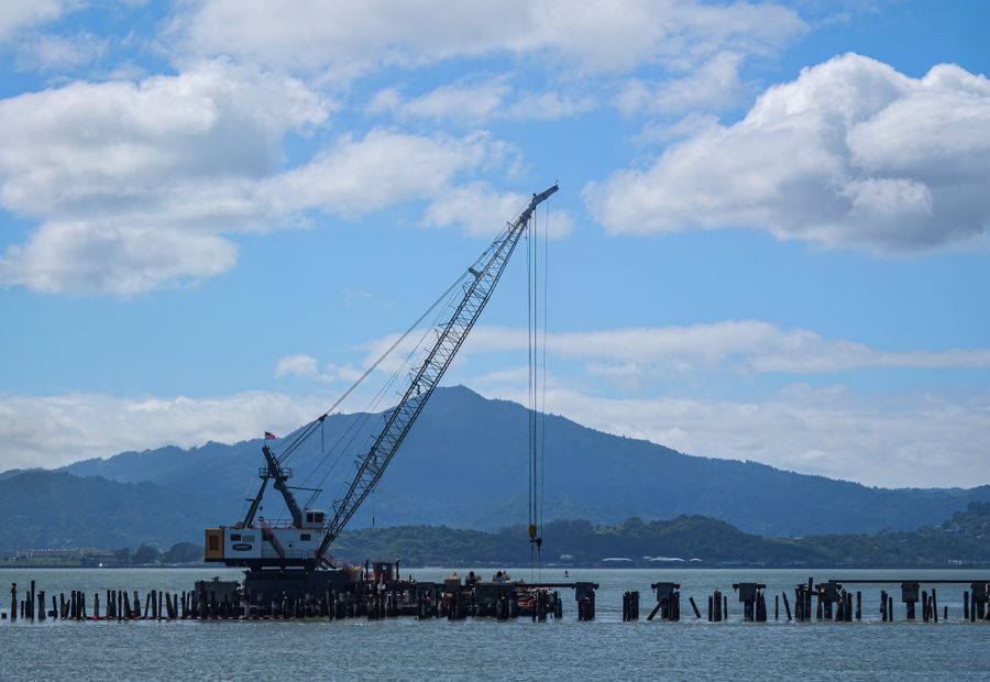 Marine crew rebuilding a seawall face along a Barnegat Bay lagoon